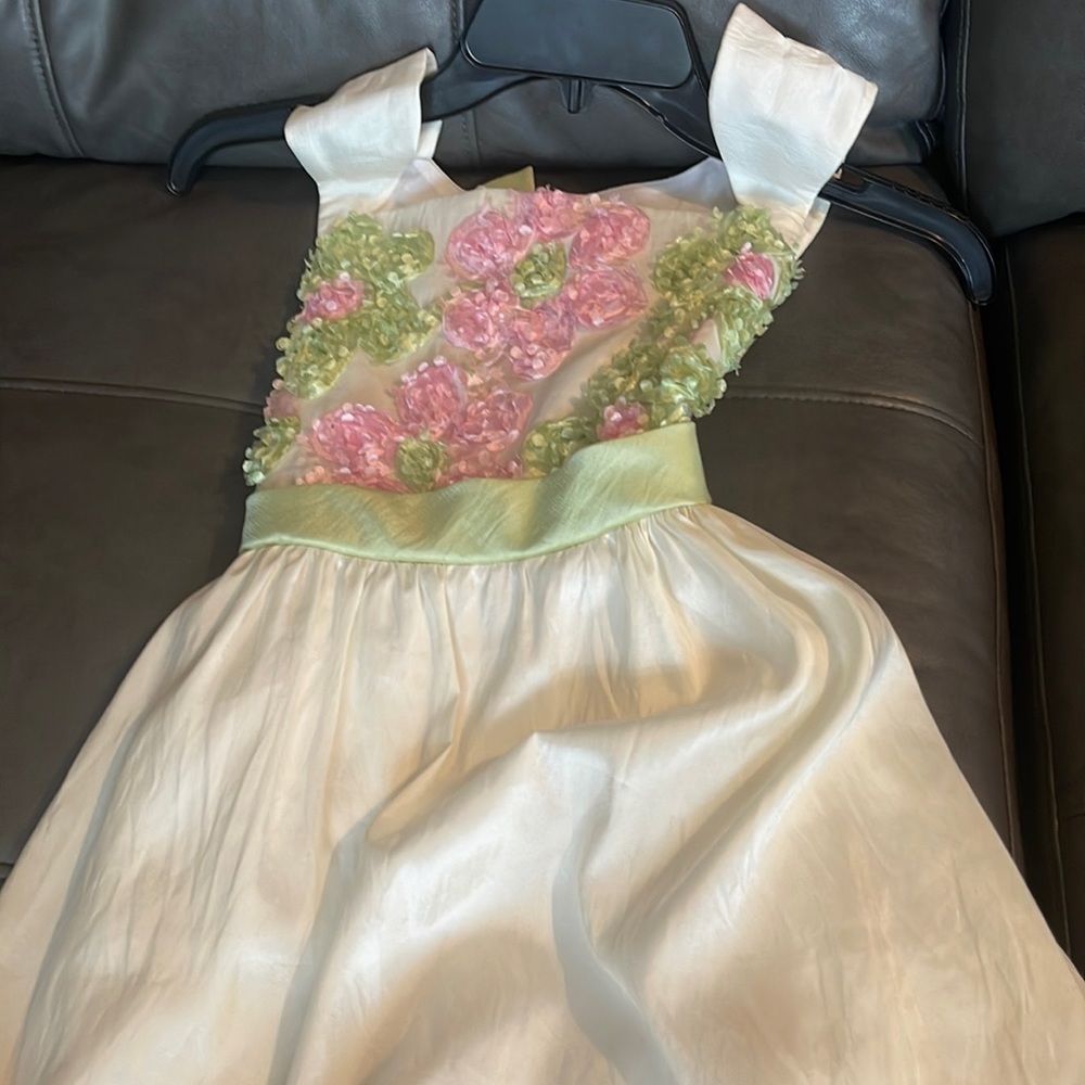 Girls dress cream, pink, and green.
